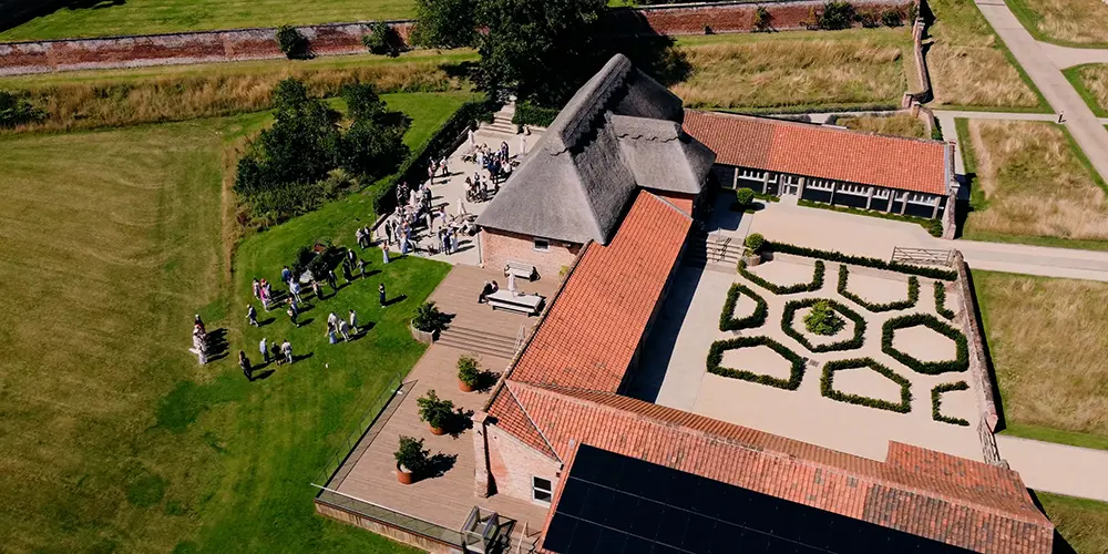 Frame from wedding video showing a drone shot over the Worstead Estate