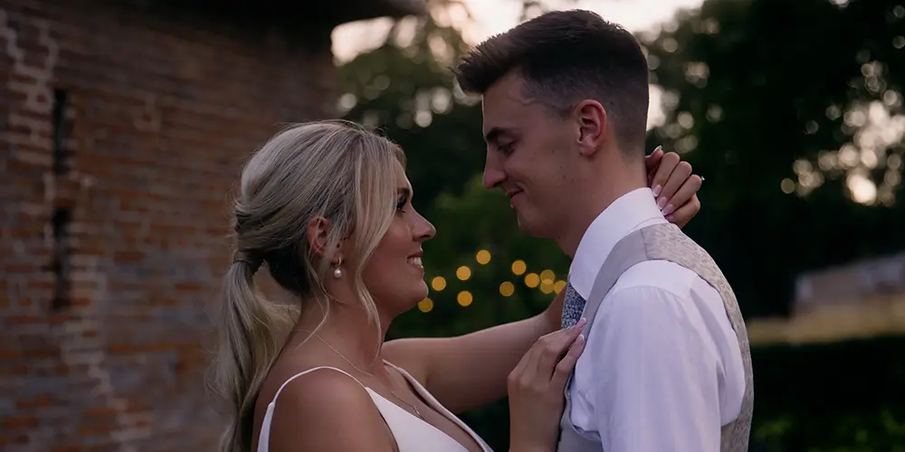Frame of a wedding couple sharing an embrace in their wedding film